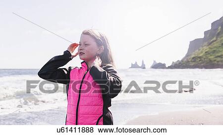 Young girl on beach, looking at view, Vik, Iceland View Large Photo Image Stock Photo - Young girl on beach, looking at view, Vik, Iceland. Fotosearch
