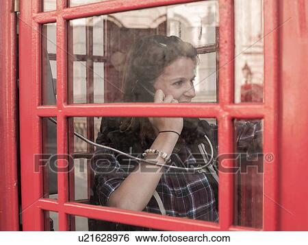 Young woman backpacker talking in red telephone box, London, UK View Large Photo Image Stock Photograph - Young woman backpacker talking in red telephone box, London, UK. Fotosearch