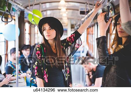 Young woman travelling on city tram View Large Photo Image Stock Photograph - Young woman travelling on city tram. Fotosearch
