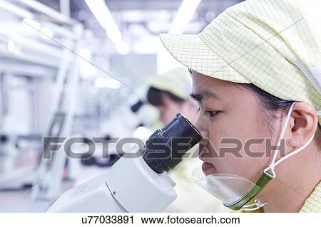Young woman using microscope at quality check station at factory producing flexible electronic circuit boards. Plant is located in the south of China, in Zhuhai, Guangdong province View Large Photo Image Stock Image - Young woman using microscope at quality check station at factory producing flexible electronic circuit boards. Plant is located in the south of China, in Zhuhai, Guangdong province. Fotosearch