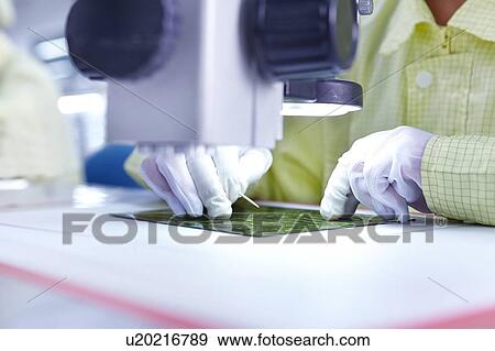 Young woman working at factory producing flexible electronic circuit boards. Plant is located in the south of China, in Zhuhai, Guangdong province View Large Photo Image Stock Photo - Young woman working at factory producing flexible electronic circuit boards. Plant is located in the south of China, in Zhuhai, Guangdong province. Fotosearch