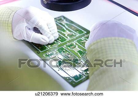Young woman working at factory producing flexible electronic circuit boards. Plant is located in the south of China, in Zhuhai, Guangdong province View Large Photo Image Stock Photo - Young woman working at factory producing flexible electronic circuit boards. Plant is located in the south of China, in Zhuhai, Guangdong province. Fotosearch
