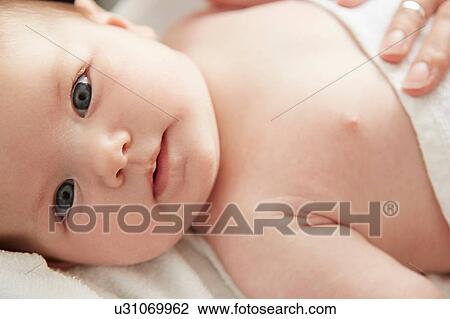 Stock Image - Baby looking at camera. Fotosearch