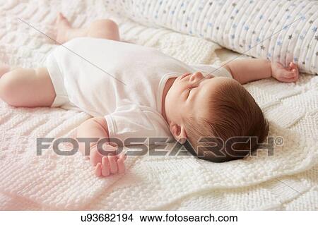 Picture - Baby sleeping in bed. Fotosearch