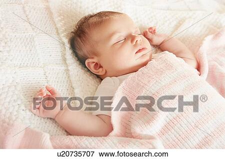 Baby sleeping in bed View Large Photo Image Stock Photo - Baby sleeping in bed. Fotosearch