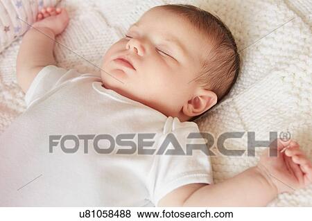 Baby sleeping in bed View Large Photo Image Stock Photo - Baby sleeping in bed. Fotosearch