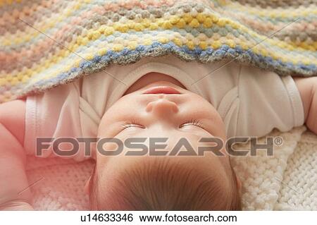Baby sleeping in bed View Large Photo Image Stock Photograph - Baby sleeping in bed. Fotosearch