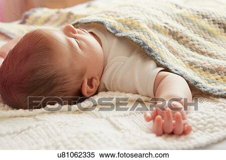 Stock Photography - Baby sleeping in bed. Fotosearch