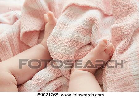 Stock Photography - Baby's legs in bed. Fotosearch