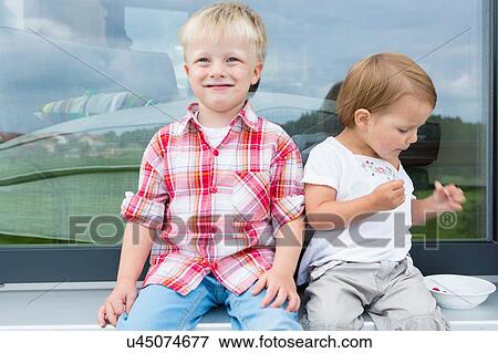 Boy and female toddler on patio eating bowl of raspberries View Large Photo Image Stock Photo - Boy and female toddler on patio eating bowl of raspberries. Fotosearch