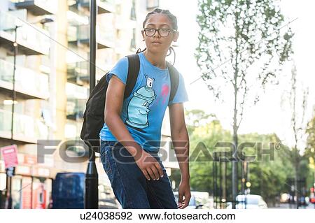 Boy skateboarding along city sidewalk View Large Photo Image Stock Image - Boy skateboarding along city sidewalk. Fotosearch