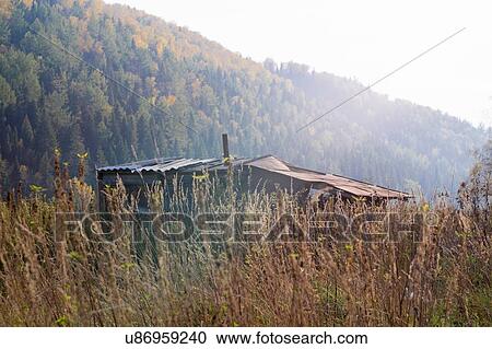 Stock Image - Cabin in field, Ural, Russia. Fotosearch