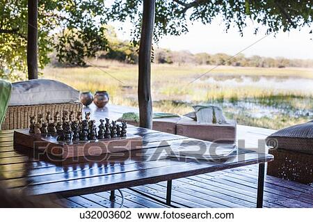 Chess board on table at safari lodge, Kafue National Park, Zambia View Large Photo Image Stock Image - Chess board on table at safari lodge, Kafue National Park, Zambia. Fotosearch