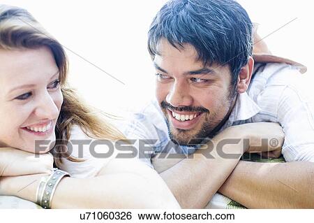 Stock Photograph - Close up portrait of happy couple making eye contact. Fotosearch