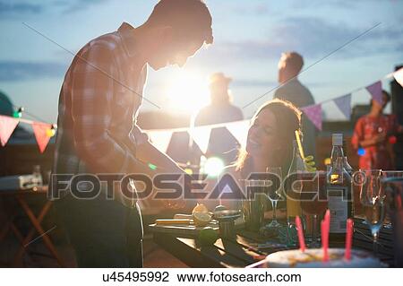Couple at early evening party View Large Photo Image Stock Image - Couple at early evening party. Fotosearch