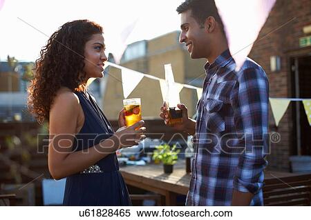 Couple at early evening party View Large Photo Image Stock Photography - Couple at early evening party. Fotosearch