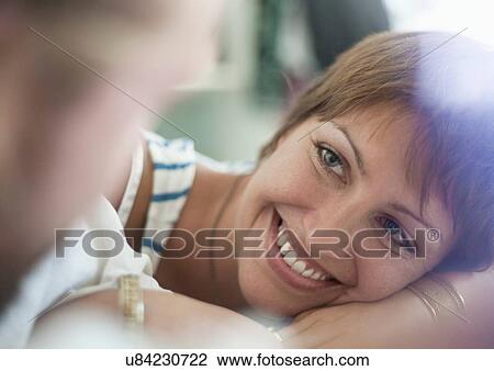Stock Image - Couple chatting in bed. Fotosearch