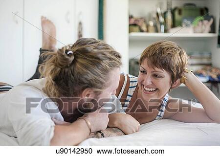 Stock Image - Couple chatting in bed. Fotosearch