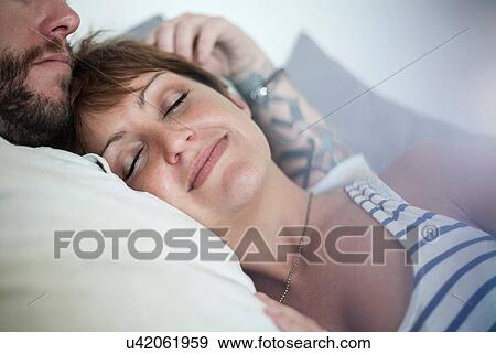 Couple in loving embrace in bed View Large Photo Image Stock Photo - Couple in loving embrace in bed. Fotosearch