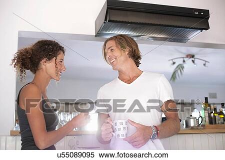 Couple in sleepwear, in kitchen, drinking coffee, smiling View Large Photo Image Stock Photography - Couple in sleepwear, in kitchen, drinking coffee, smiling. Fotosearch