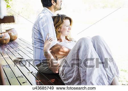 Stock Photo - Couple looking out from safari lodge, Kafue National Park, Zambia. Fotosearch