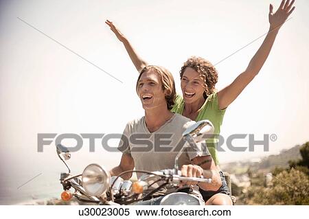 Couple of moped, excited expressions View Large Photo Image Stock Photography - Couple of moped, excited expressions. Fotosearch