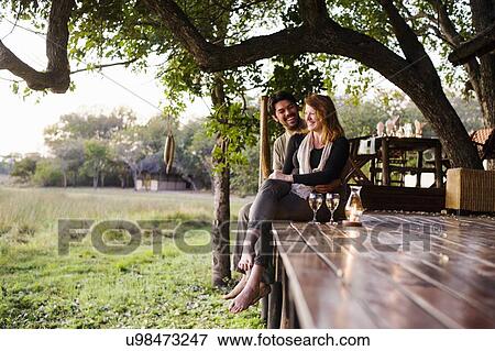 Couple relaxing at safari lodge, Kafue National Park, Zambia View Large Photo Image Stock Photo - Couple relaxing at safari lodge, Kafue National Park, Zambia. Fotosearch