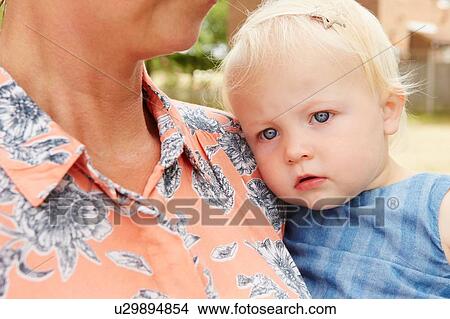 Picture - Cropped view of mother holding baby girl. Fotosearch