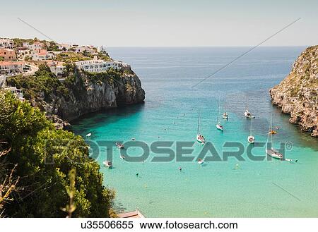 Stock Photography - Elevated view of two boats and yachts anchored in bay, Menorca, Balearic islands, Spain. Fotosearch