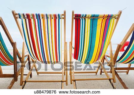 Empty deckchairs in a row View Large Photo Image Stock Photograph - Empty deckchairs in a row. Fotosearch