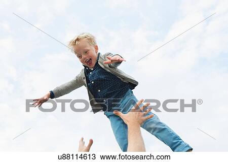 Father throwing son mid air View Large Photo Image Stock Image - Father throwing son mid air. Fotosearch