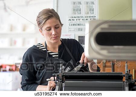 Female letterpress printer inking machine in workshop View Large Photo Image Picture - Female letterpress printer inking machine in workshop. Fotosearch