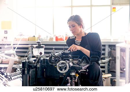 Female letterpress printer inking print machine in workshop View Large Photo Image Stock Photo - Female letterpress printer inking print machine in workshop. Fotosearch