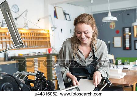 Female printer inserting paper to print machine in workshop View Large Photo Image Stock Image - Female printer inserting paper to print machine in workshop. Fotosearch