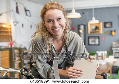 Female printer inserting paper to printing machine in workshop View Large Photo Image Stock Image - Female printer inserting paper to printing machine in workshop. Fotosearch