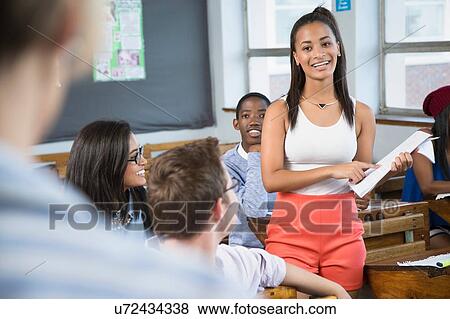 Female student making presentation to class View Large Photo Image Stock Photo - Female student making presentation to class. Fotosearch