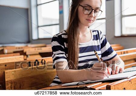 Female student working in empty classroom View Large Photo Image Stock Photo - Female student working in empty classroom. Fotosearch