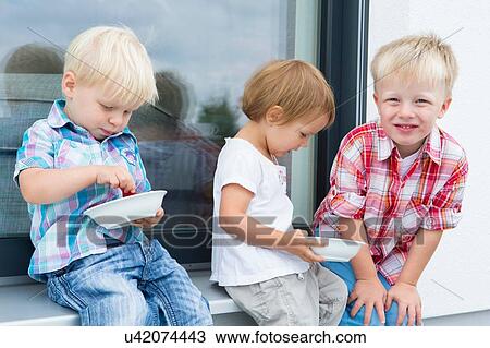 Female toddler and two young brothers on patio eating bowls of raspberries View Large Photo Image Stock Image - Female toddler and two young brothers on patio eating bowls of raspberries. Fotosearch