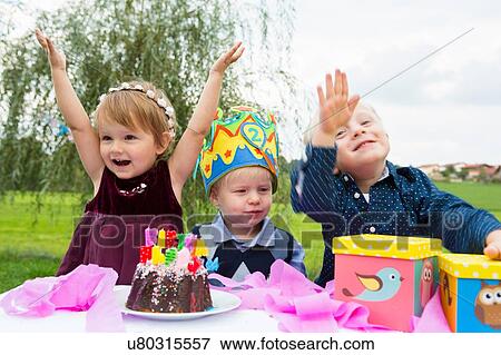 Female toddler and two young brothers at birthday party in garden View Large Photo Image Stock Photo - Female toddler and two young brothers at birthday party in garden. Fotosearch