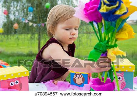 Female toddler with paper flowers at birthday party in garden View Large Photo Image Stock Photo - Female toddler with paper flowers at birthday party in garden. Fotosearch
