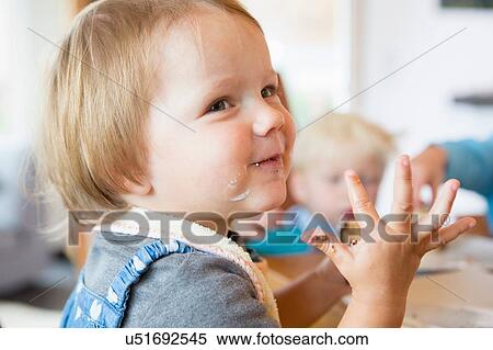 Female toddler with sticky hands at tea table View Large Photo Image Stock Photography - Female toddler with sticky hands at tea table. Fotosearch