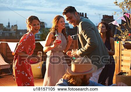 Stock Photography - Friends at early evening party. Fotosearch