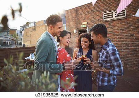 Stock Photography - Friends at early evening party. Fotosearch