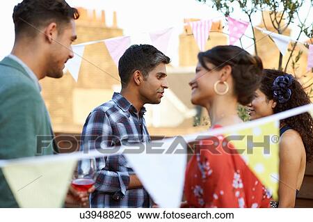 Friends at early evening party View Large Photo Image Stock Photography - Friends at early evening party. Fotosearch