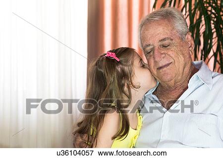 Girl kissing grandfather's cheek View Large Photo Image Stock Photo - Girl kissing grandfather's cheek. Fotosearch