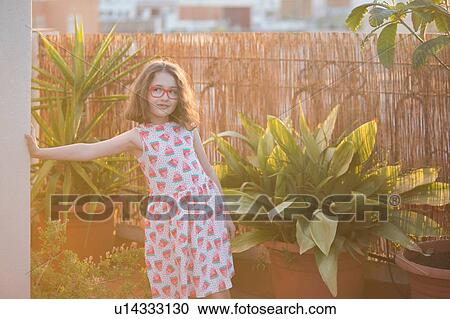 Girl leaning wearing sundress and eye glasses leaning against wall looking away View Large Photo Image Stock Image - Girl leaning wearing sundress and eye glasses leaning against wall looking away. Fotosearch