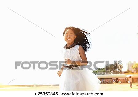 Girl wearing white dress running on beach, Zhuhai, Guangdong, China View Large Photo Image Stock Photography - Girl wearing white dress running on beach, Zhuhai, Guangdong, China. Fotosearch