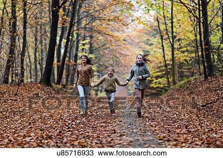 Girls running in autumn forest View Large Photo Image Stock Image - Girls running in autumn forest. Fotosearch