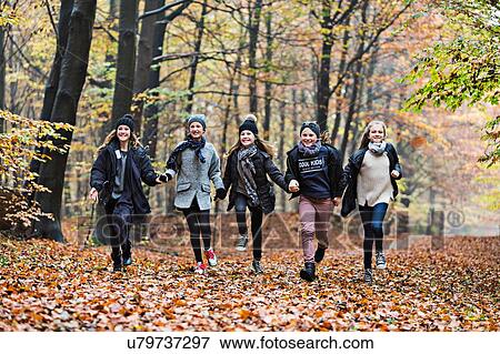Girls running in autumn forest View Large Photo Image Stock Photo - Girls running in autumn forest. Fotosearch