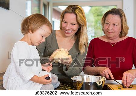Grandmother, daughter and toddler granddaughter preparing dough in kitchen View Large Photo Image Stock Image - Grandmother, daughter and toddler granddaughter preparing dough in kitchen. Fotosearch